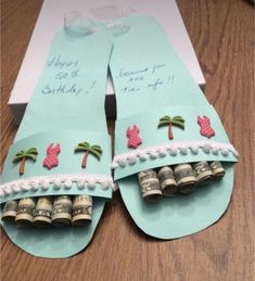 two pairs of sandals made out of dollar bills with palm trees and pink flowers on them