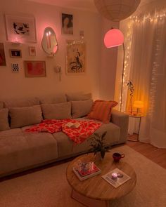 a living room filled with furniture and pictures hanging on the wall above it's coffee table