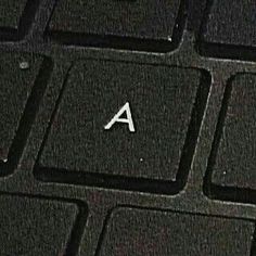 a computer keyboard with the letter a on it's key and an arrow in the middle