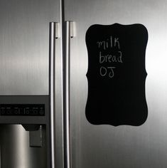 a stainless steel refrigerator with a chalk board on the door that says milk bread 70