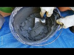 someone is pouring cement into a bucket