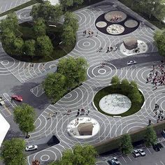 an aerial view of a parking lot with many trees and people walking around the area