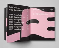 an open book with black and pink covers