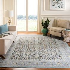 a living room filled with furniture and a large rug