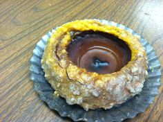 a chocolate filled pastry sitting on top of a wooden table