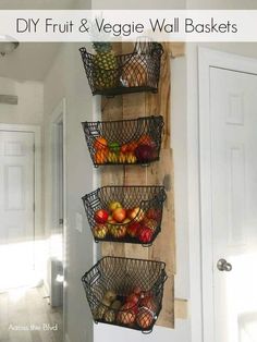 three metal baskets filled with fruit on top of a wooden wall hanging from the side of a door