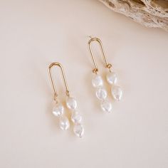 Add a touch of whimsy to your look with our Sydney Pearl Earrings! These delightful earrings feature genuine freshwater pearls, each one hand wire-wrapped with 14k gold-fill wire. With their unique arched post design and natural variations in shape and size, these earrings exude a unique, playful charm! Let these one-o Natural Pearl Necklace, Woven Ring, Freshwater Pearl Jewelry, Earring Collection, Semi Precious Beads, Pretty Earrings, Pearl Stud Earrings, Opal Necklace, Jewelry Business