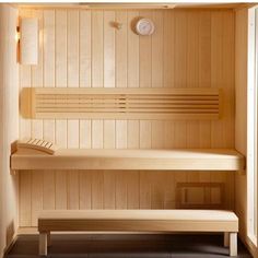 the inside of a sauna with two benches and a clock mounted on the wall