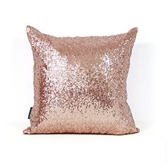 a pillow that is made out of sequins on the side of a white wall