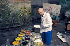 an older man is painting in his studio