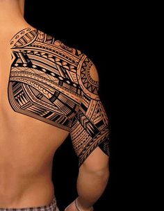 the back of a man's upper half with an intricate tattoo design on it