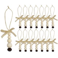 several wooden beads hang from string with bows on white and black beaded strings,