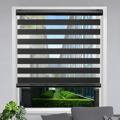 a living room scene with focus on the blinds in the window, and an outdoor garden