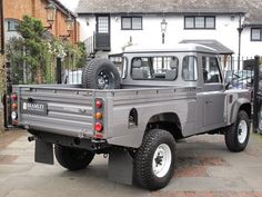 a grey truck parked in front of a house