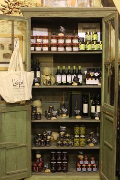 an open cabinet with spices and condiments in it