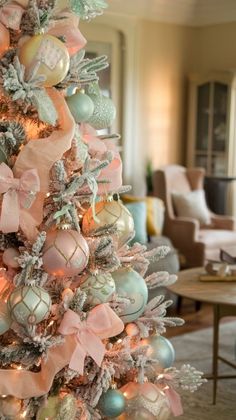 a decorated christmas tree with pastel colors and bows in a living room or dining room