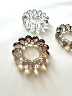 three different colored rings sitting on top of a white table