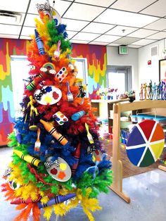 a brightly colored christmas tree in an art room