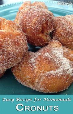 some sugared doughnuts on a blue plate with the words easy recipe for homemade cronuts