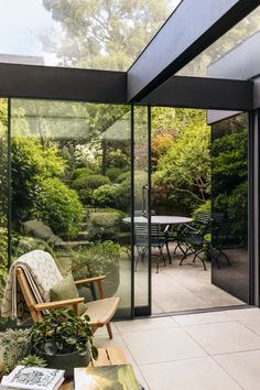 an open patio with chairs and tables in the middle, surrounded by greenery on both sides