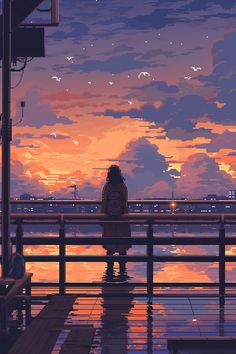 a person sitting on a bench looking at the sunset