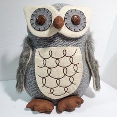 an owl stuffed animal sitting on top of a white table