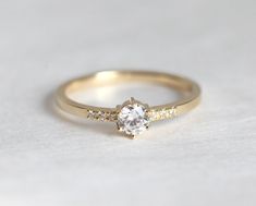 a gold engagement ring with a single diamond