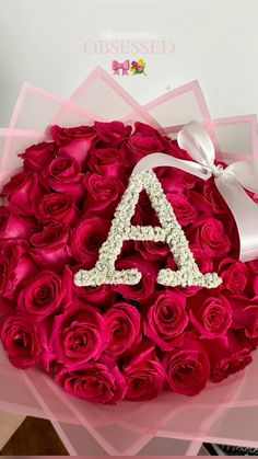 a bouquet of roses with the letter a on it