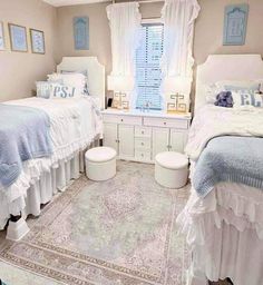 two twin beds in a bedroom with blue and white decor on the walls, along with an area rug