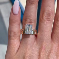 a woman's hand with a ring on it and a diamond in the middle