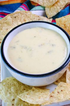 a bowl of dip surrounded by tortilla chips