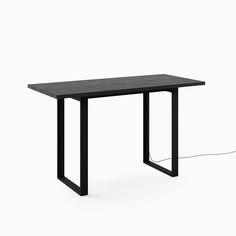 a wooden table with black metal legs and an electric outlet plugged into the top