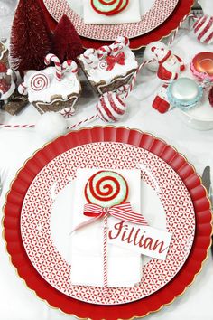 red and white plates with candy canes on them are set for a holiday dinner