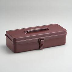 a brown suitcase sitting on top of a white table