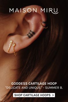 a woman wearing ear piercings with the words, goddess cartilage hoop delicate and unique summer b - shop cartilage hoops