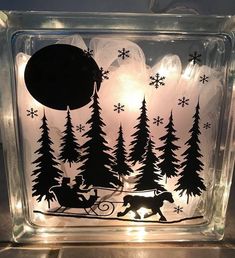 a glass block with an image of a bear pulling a sleigh through the woods