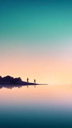 two people are running on the beach at sunset or sunrise with mountains in the background