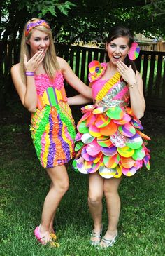 two girls dressed in colorful costumes posing for the camera