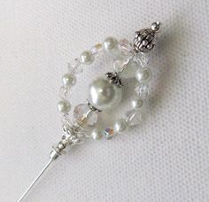 a white beaded brooch with crystal beads