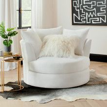 a white chair sitting in a living room on top of a hard wood floor next to a window