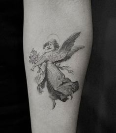 a woman with an angel tattoo on her arm is holding a flower in her hand