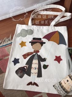 a white bag with an image of a person holding an umbrella and stars on it