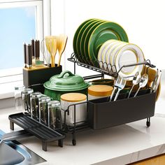 the dish rack is filled with dishes and utensils