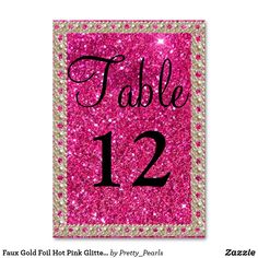 pink glitter table number sign with the word table 12 in black and white on it