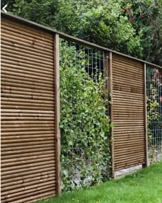 a wooden fence with plants growing on the top and bottom panels, along side it