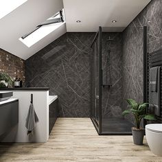 a modern bathroom with black and white tile on the walls, wood flooring and skylights