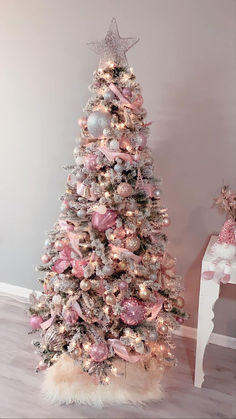 a pink and silver christmas tree with ornaments