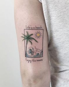 a woman with a tattoo on her arm that reads, life is a beach enjoy the waves