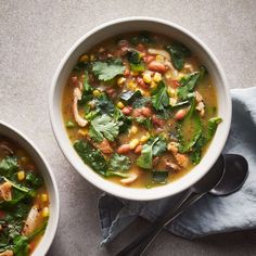 two bowls filled with soup on top of a table