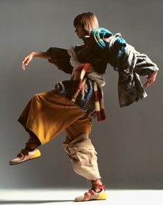 a young man is dancing on a white background